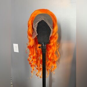Brand new orange synthetic wig. 13 x 2.5 parting space. 26 inches